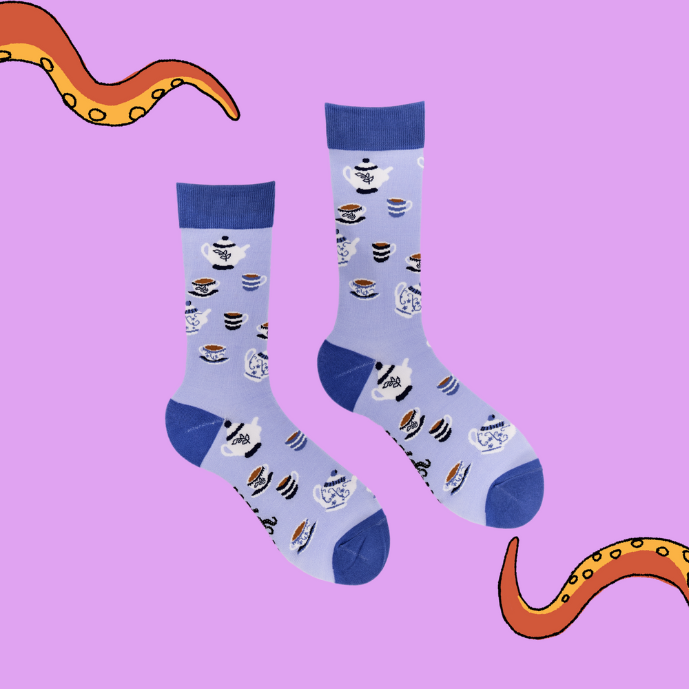 
                      
                        A pair of socks depicting tea cups and tea pots. Light blue legs, blue cuff, heel and toe.
                      
                    