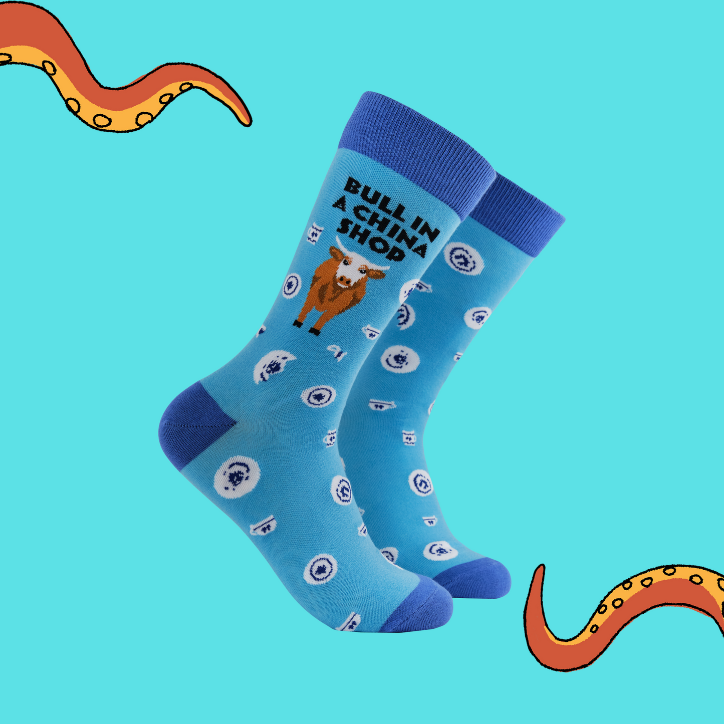 A pair of socks featuring a bull in a china shop. Light blue legs, dark blue heel, toe and cuff. 