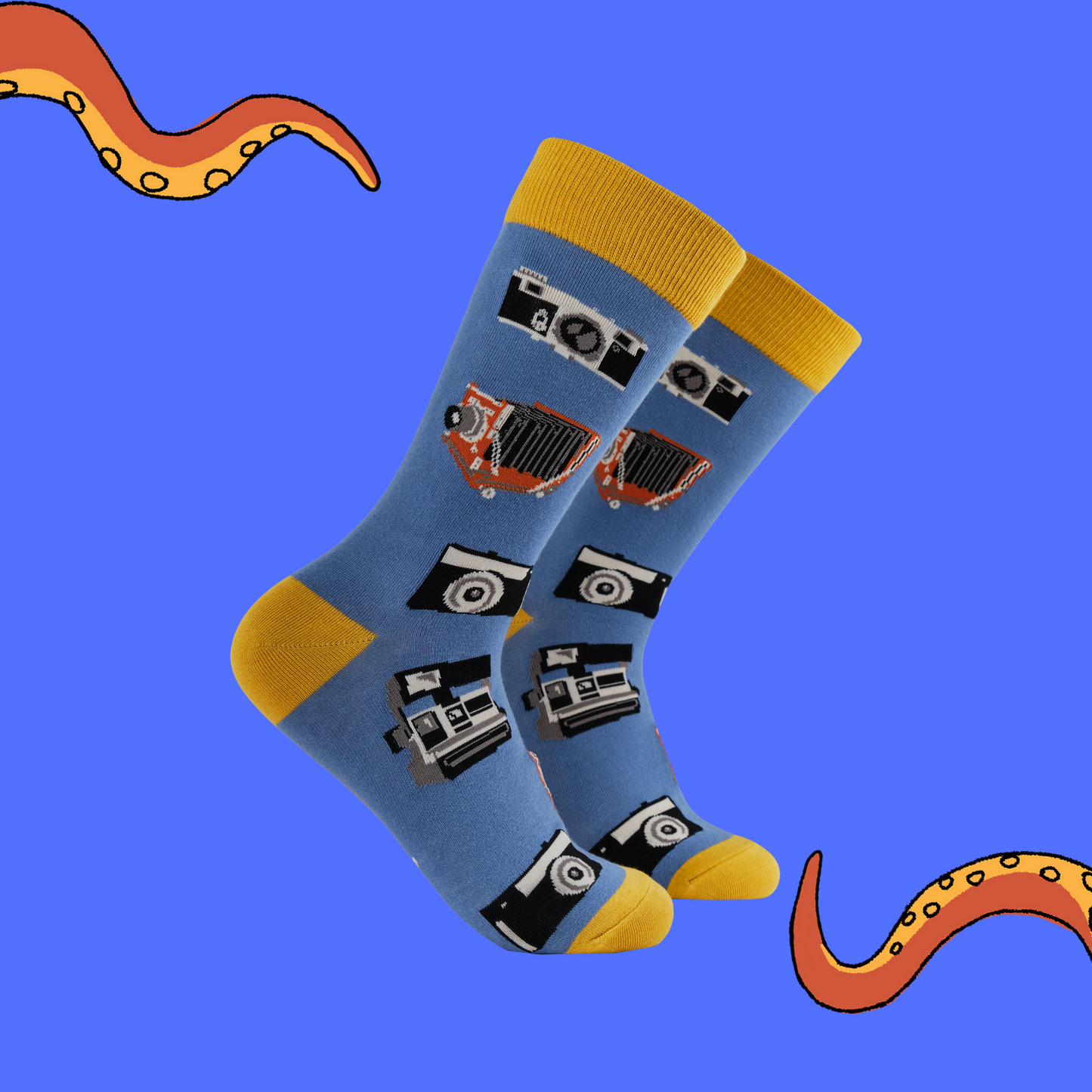 A pair of socks with a vintage camera motif. Blue legs, yellow heel, toe and cuff. 