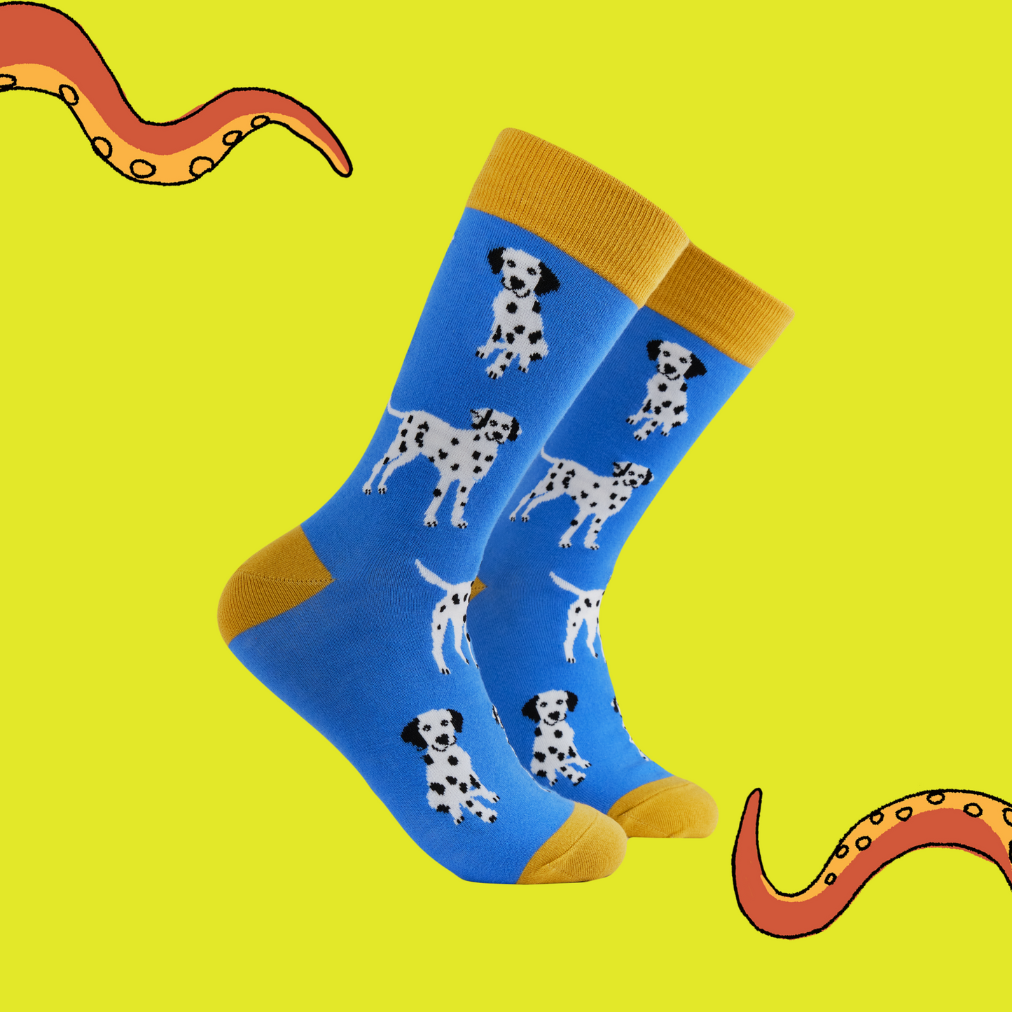 A pair of socks with a dalmatian motif. Blue legs, yellow heel, toe and cuff. 