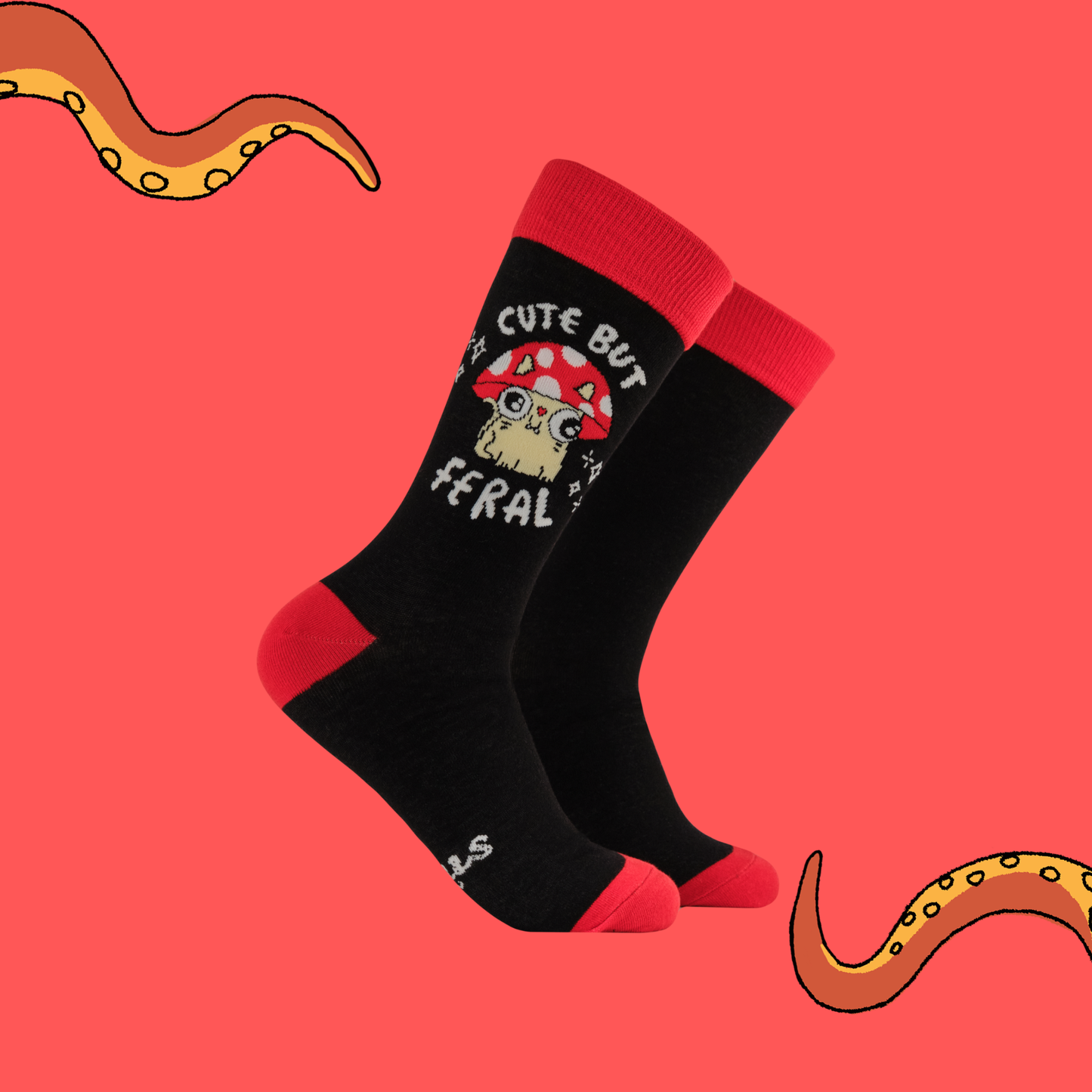 Black socks with red accents and a graphic design on a pink background