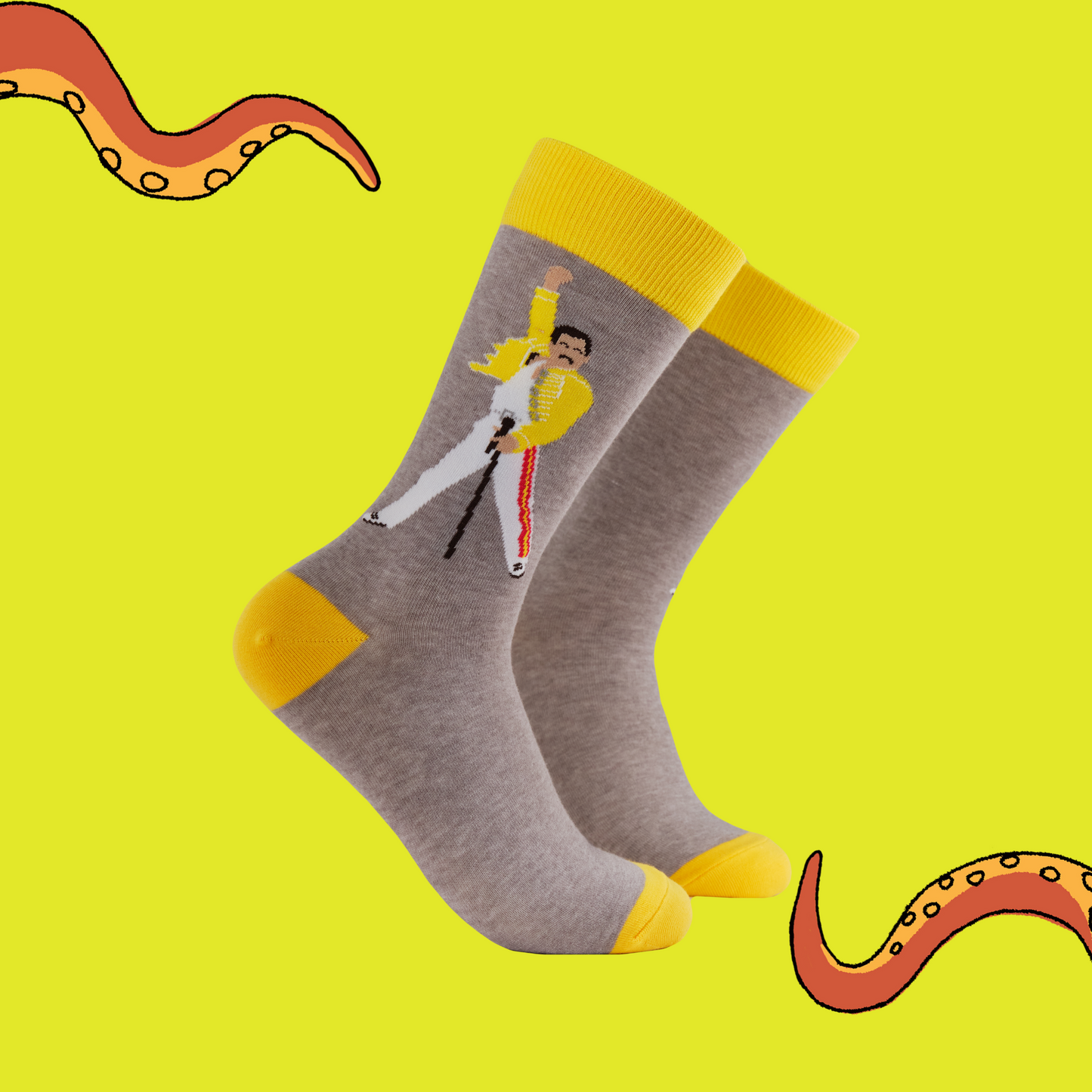 A pair of socks featuring Freddie Mercury. Grey legs, yellow heel, toe and cuff. 