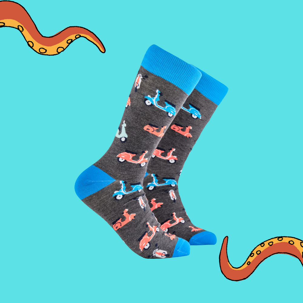 A pair of socks depicting vintage scooters. Grey legs, blue cuff, heel and toe.