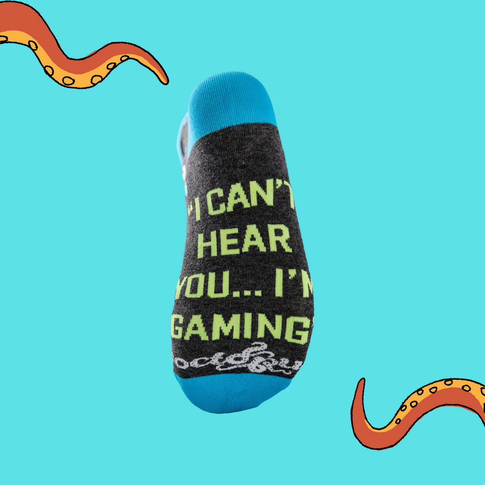 
                      
                        A pair of socks depicting game controllers and consoles. Grey legs, blue cuff, heel and toe. In Soctopus Packaging.
                      
                    