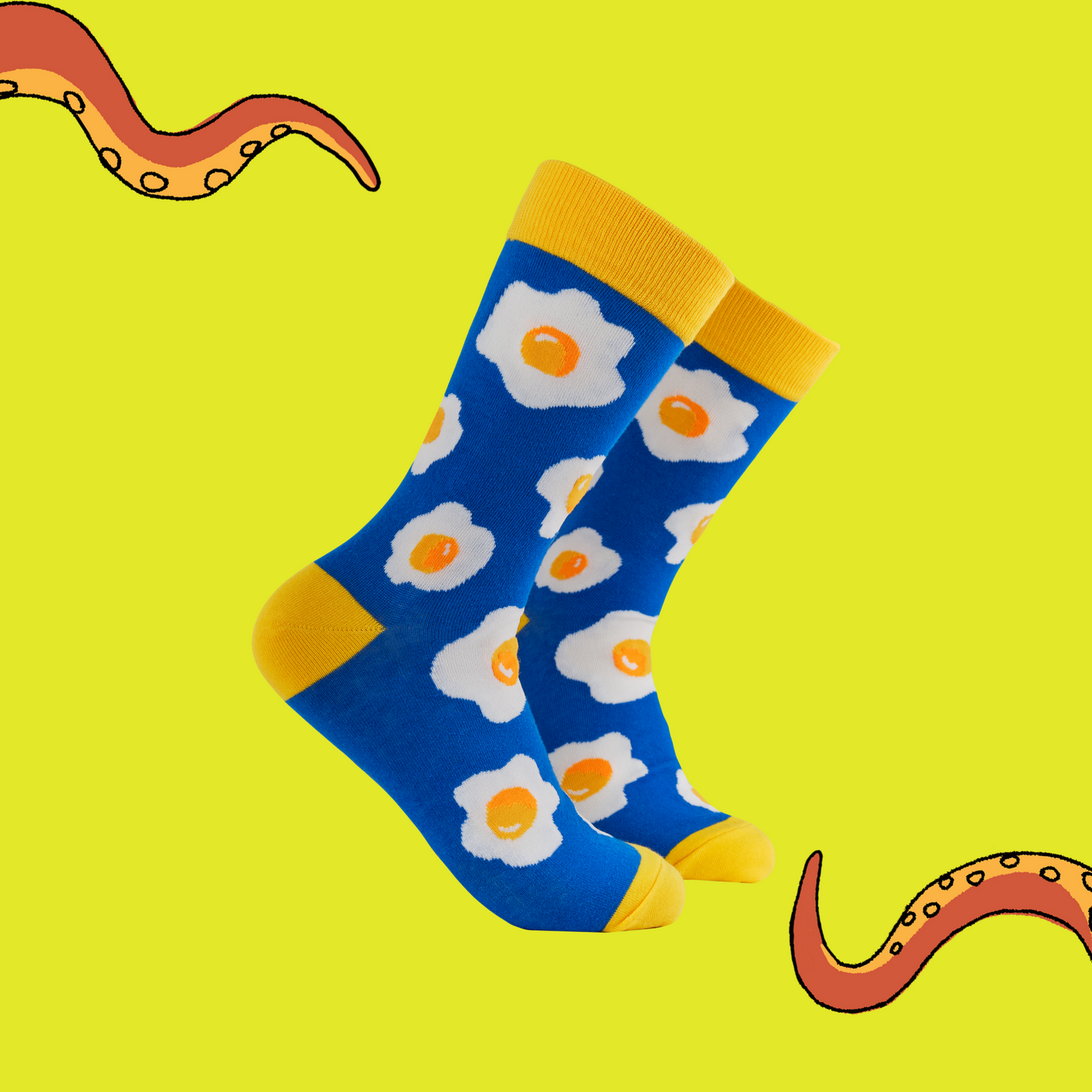 A pair of socks featuring a fried egg motif. Blue legs, yellow heel, toe and cuff. 