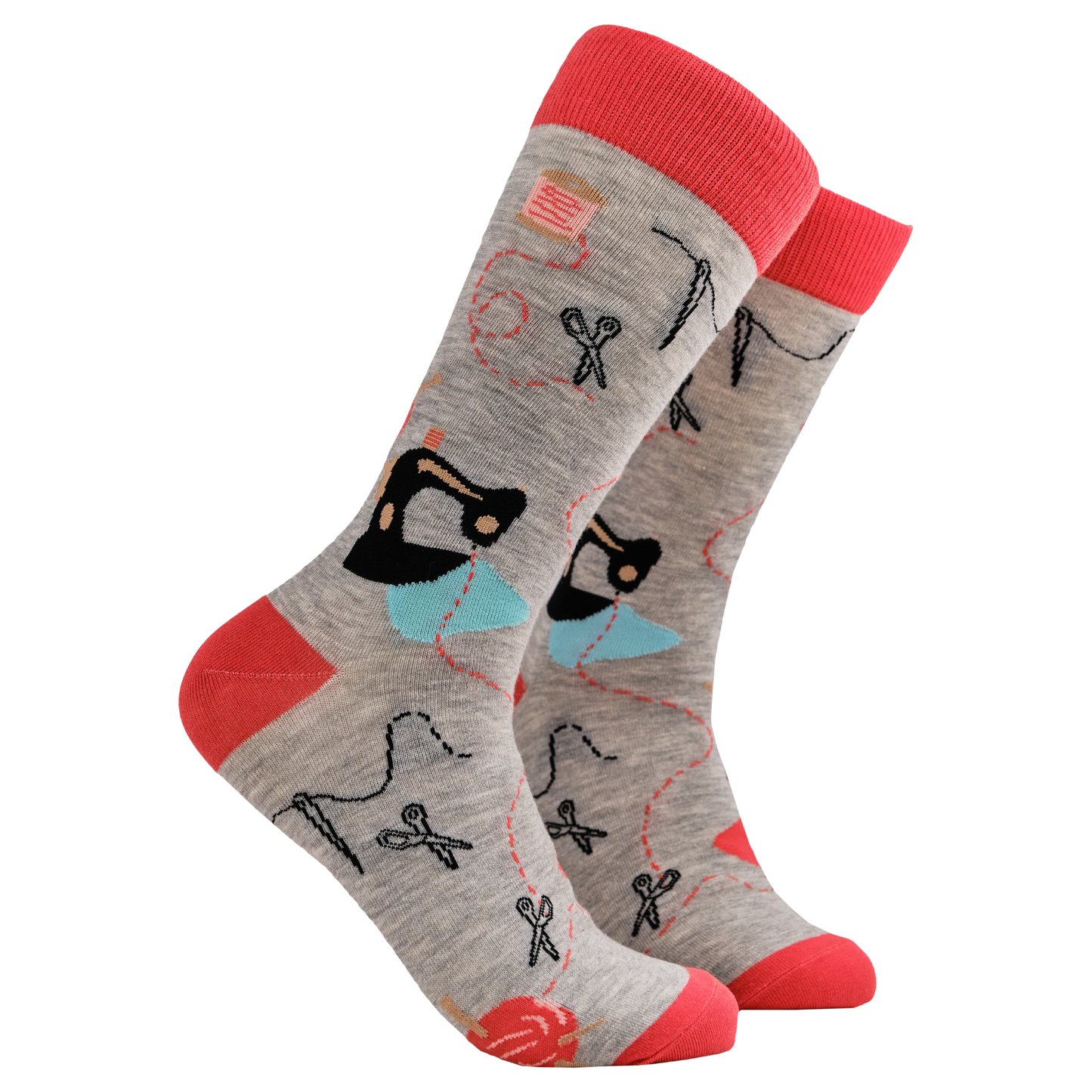 Crafty Socks. A pair of socks depicting needle and threads, sewing machines, yarn balls and general sewing and crafting equipment. Grey legs, red cuff, heel and toe.