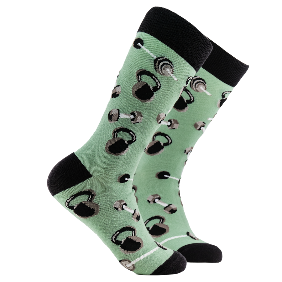 Gym Socks - Feel the Burn. A pair of socks depicting dumb bells and kettle bells. Green legs, black cuff, heel and toe.
