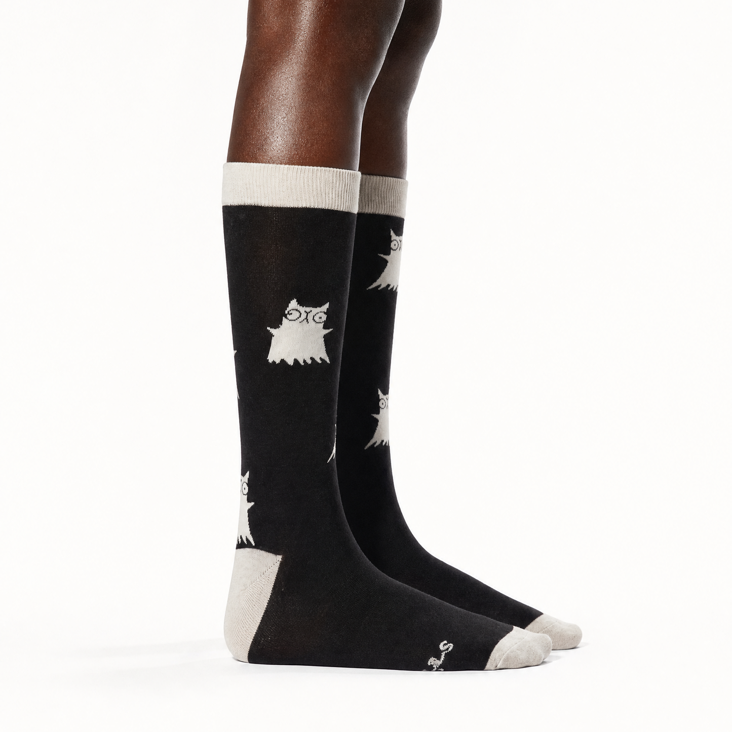 A pair of black knee-high socks worn on a model's legs against a plain white background.