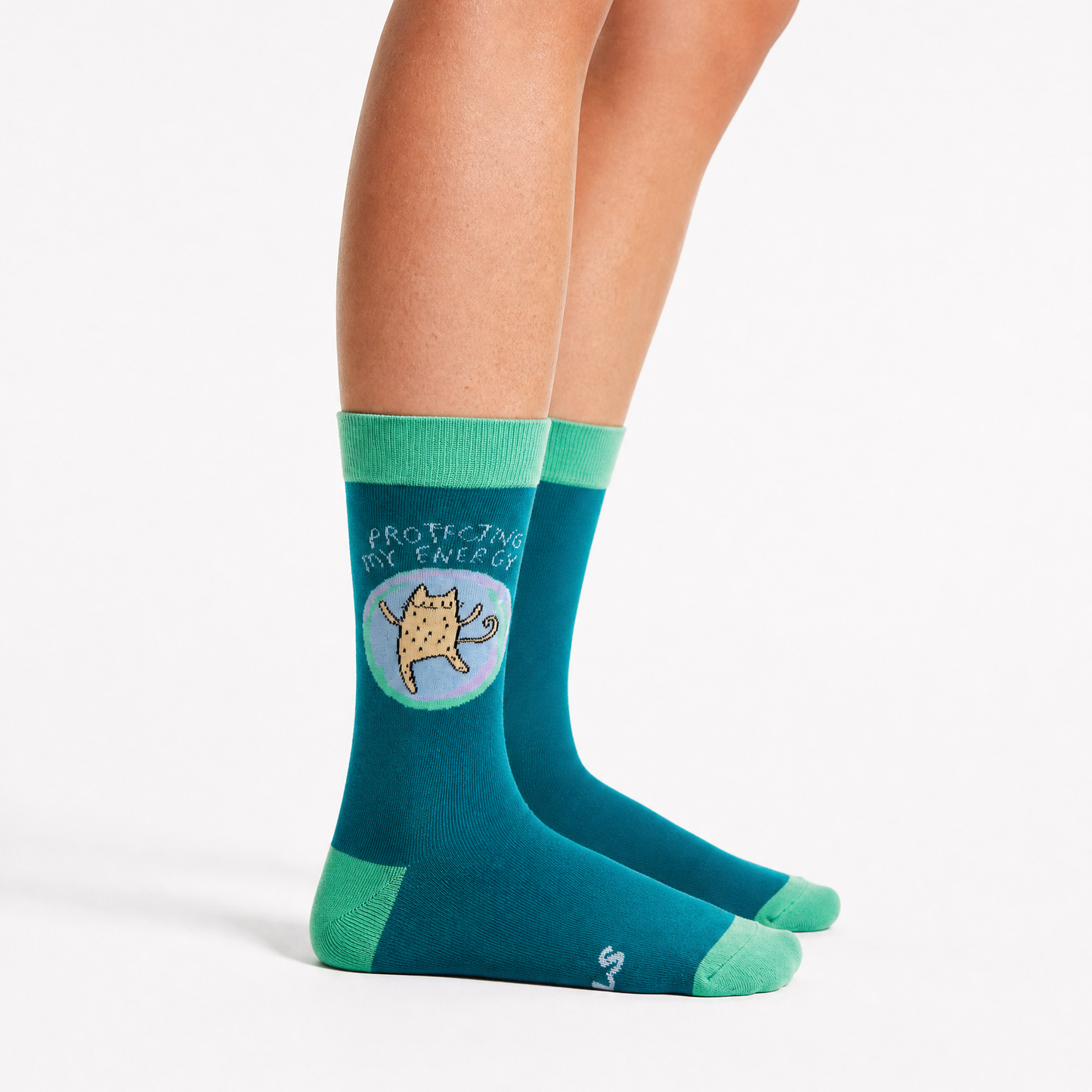 A pair of crew socks worn on a person's feet, shown against a clean white studio background. 