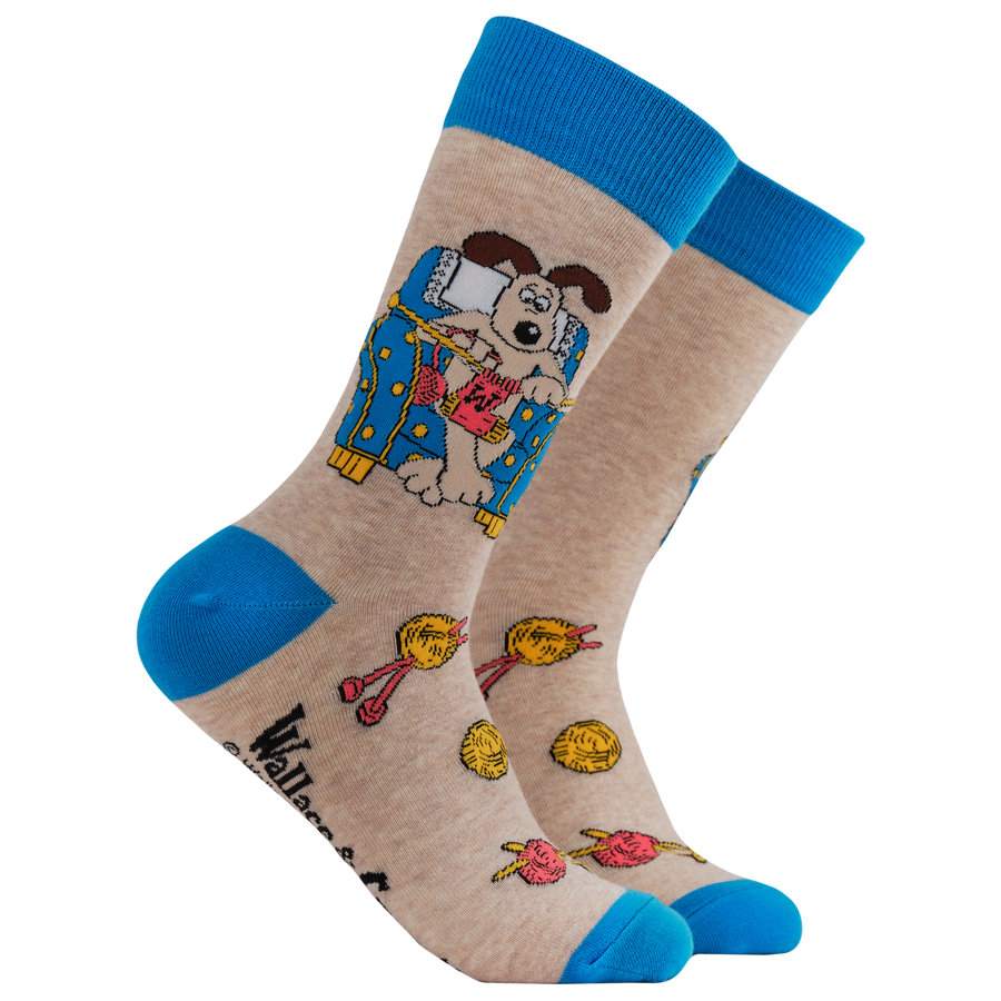Gromit Knitting Socks - Socktopus X Wallace & Gromit. A pair of socks. featuring Gromit knitting. Blue heel, toe and cuff. 