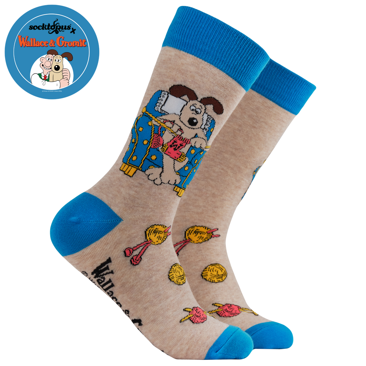 Gromit Knitting Socks - Socktopus X Wallace & Gromit. A pair of socks. featuring Gromit knitting. Blue heel, toe and cuff. 