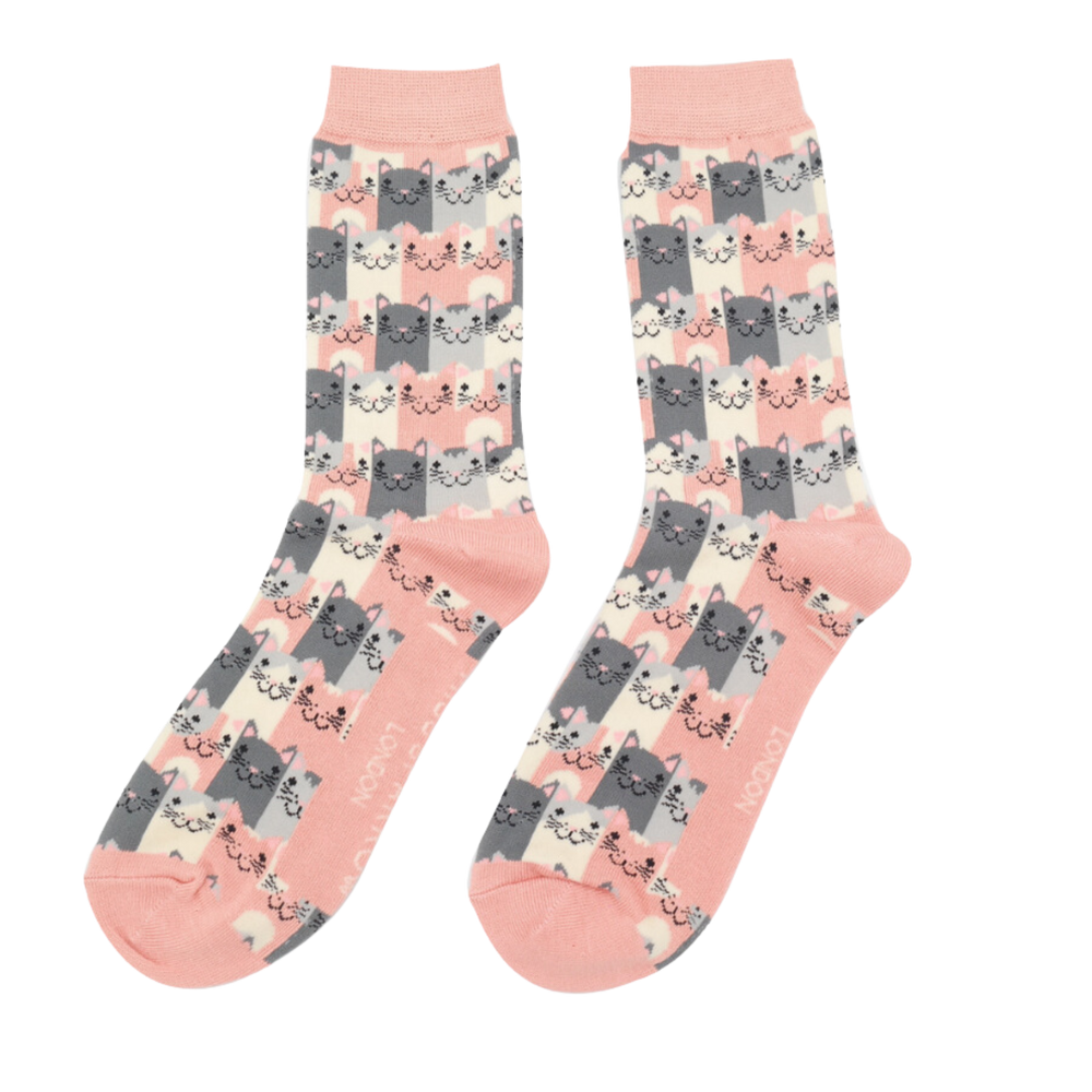 A pair of socks with a multicoloured happy anime cat pattern.  Peach heel, toe and cuff.
