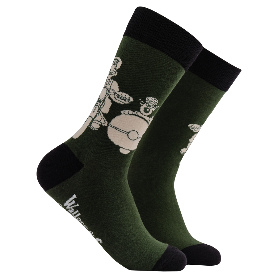 Motorbike Socks - Socktopus X Wallace & Gromit. A green pair of socks featuring Wallace & Gromit in a motorbike and sidecar.