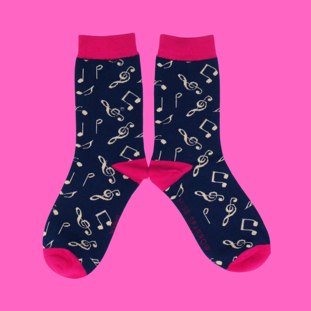 
                      
                        A pair of socks with a music note motif. Dark blue legs, bright pink heel toe and cuff. 
                      
                    