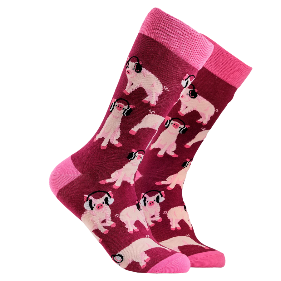 Pigs in Headphones Socks. A pair of socks depicting Pigs being wearing headphones. Burgundy legs, pink cuff, heel and toe.