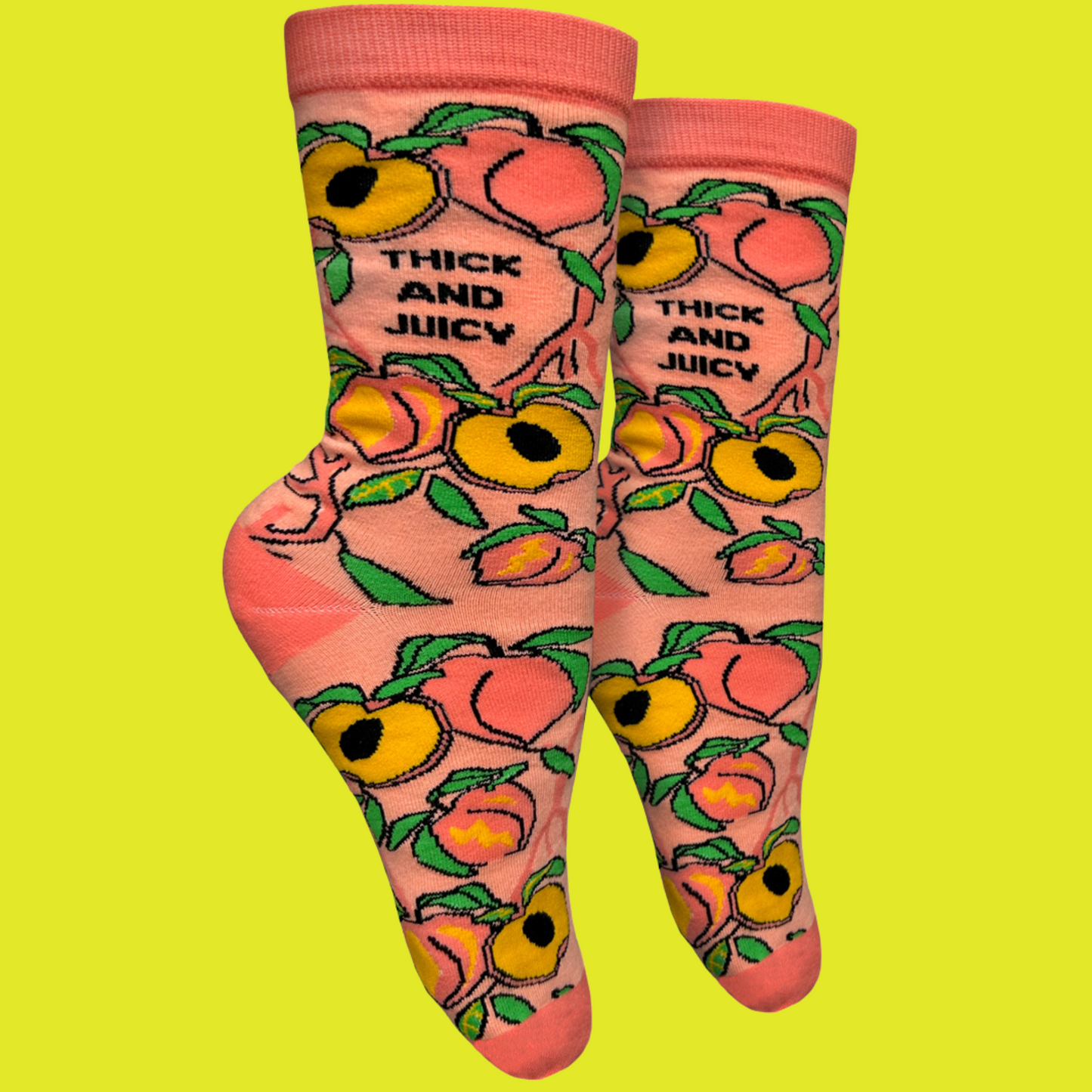 A pair of socks with a blold slogan and bold peach design. Orange toes, heel and cuff.