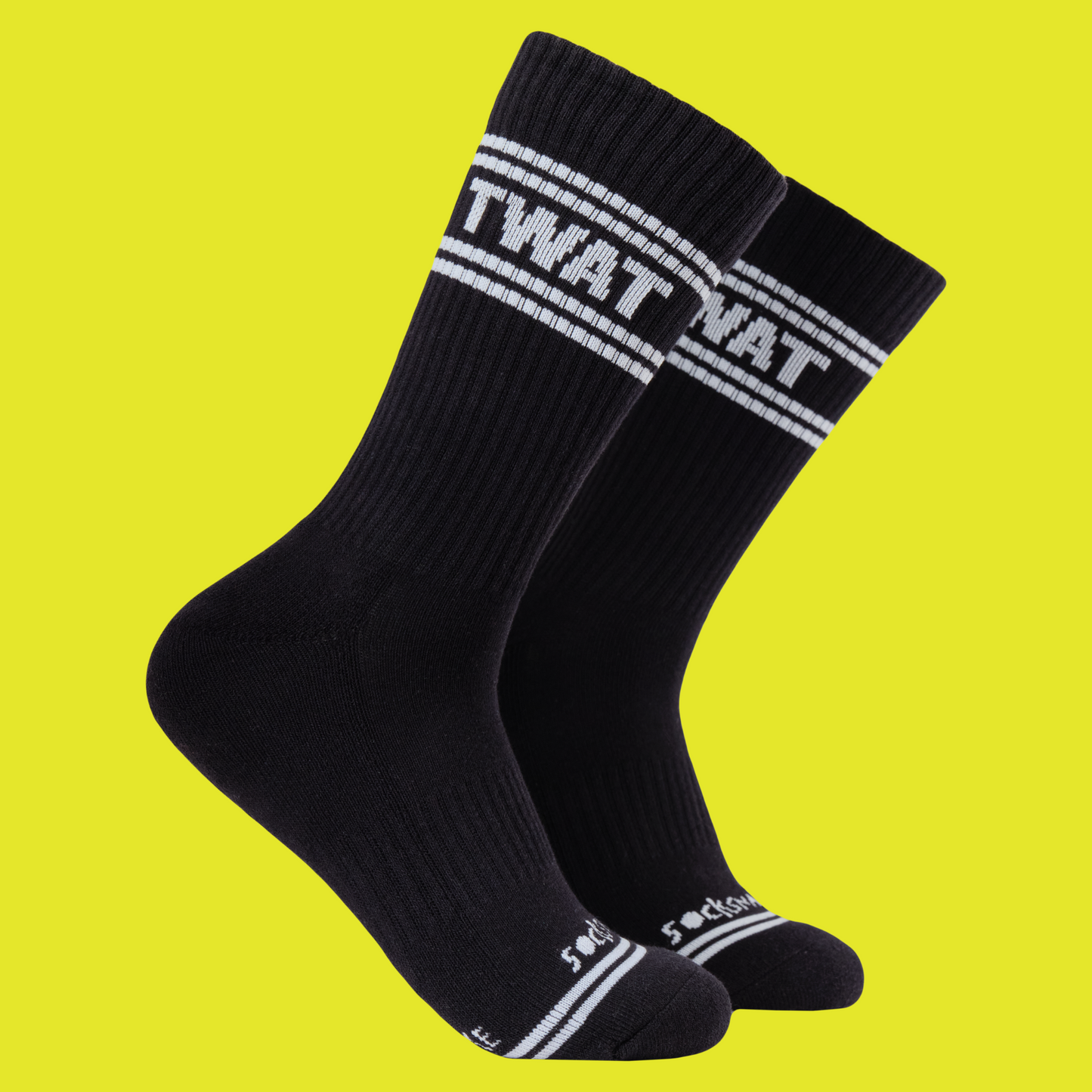 A black pair of athletic socks with white trim on the ankles and toes. A euphemism for the female genitals on the ankle.