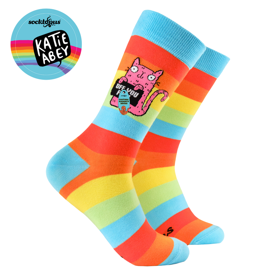 Colourful striped socks with a cartoon cat design on a white background, featuring the brand 'Katie Abey'.