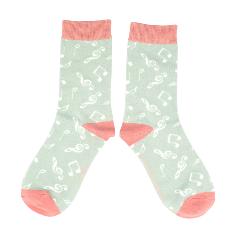 
                      
                        A pair of socks with a music note motif. Light green legs, pink heel toe and cuff. 
                      
                    