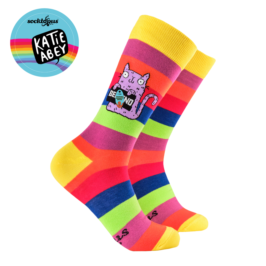 Colorful striped sock with a cat design on a white background, featuring the brand 'Katie Abbey'.