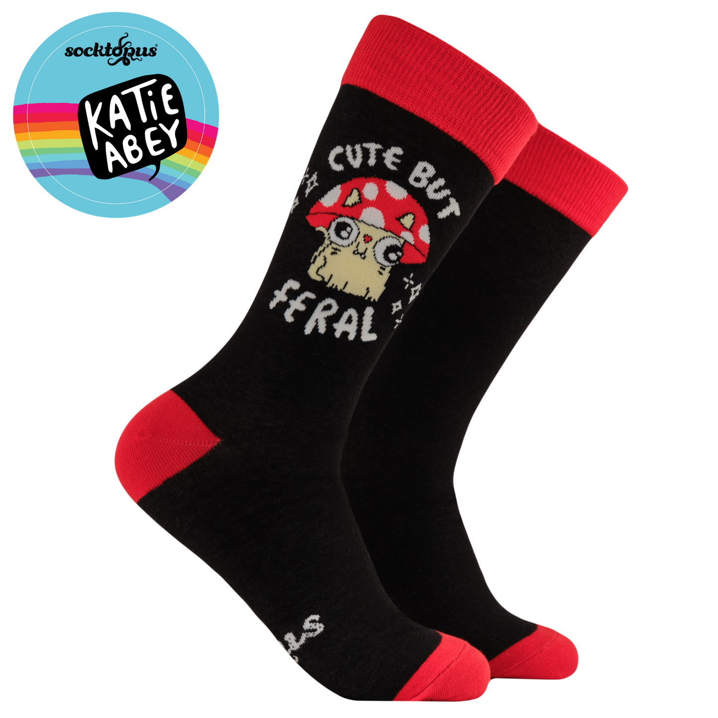 Black socks with red accents featuring a cartoon mushroom and text, on a white background with Katie Abey logo.