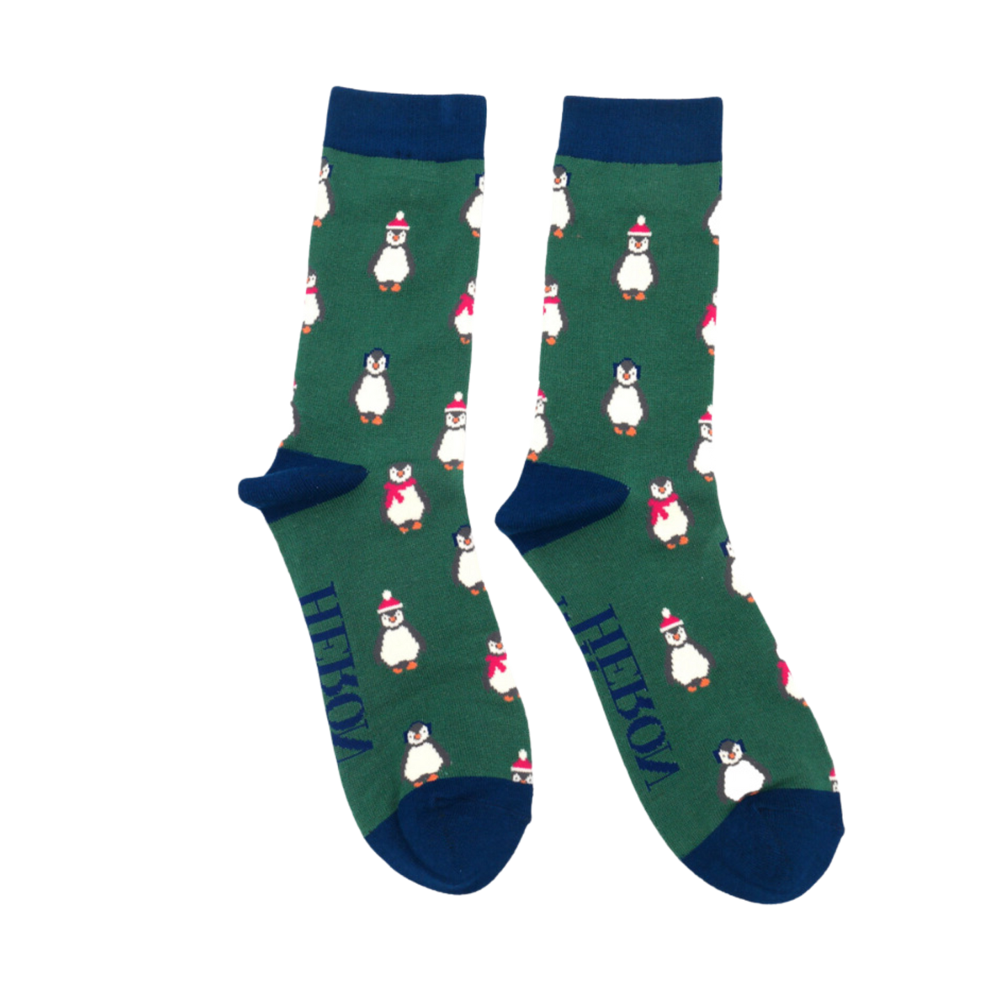 A pair of socks depicting penguins wearing hats and scarves for the winter. Green legs, blue toes, heels and cuffs. 