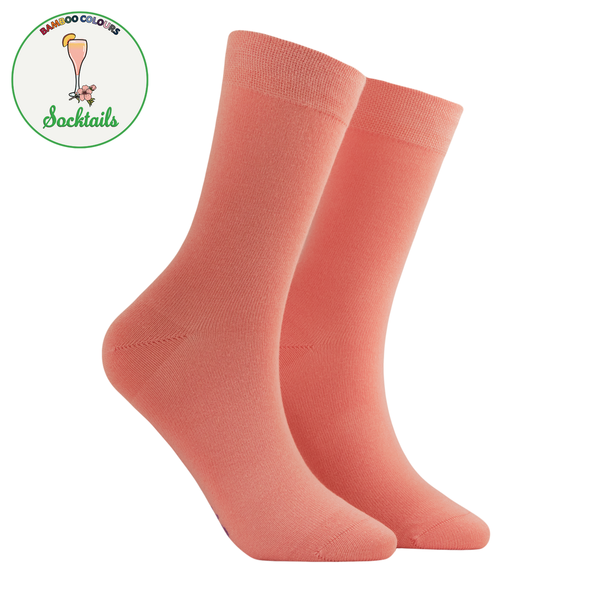 A pair of crew socks in a solid coral pink color, displayed on a clean white background with a circular 'Bamboo Colors Socktails' logo in the top-left corner.