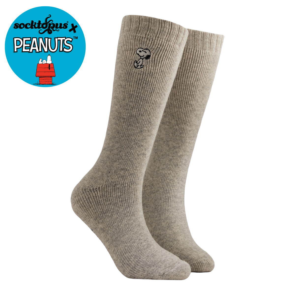 A pair of heather gray ribbed crew socks with a small black Snoopy graphic on the side, shown on a white background with a blue circular 'sockitdugus x PEANUTS' logo in the top-left corner.