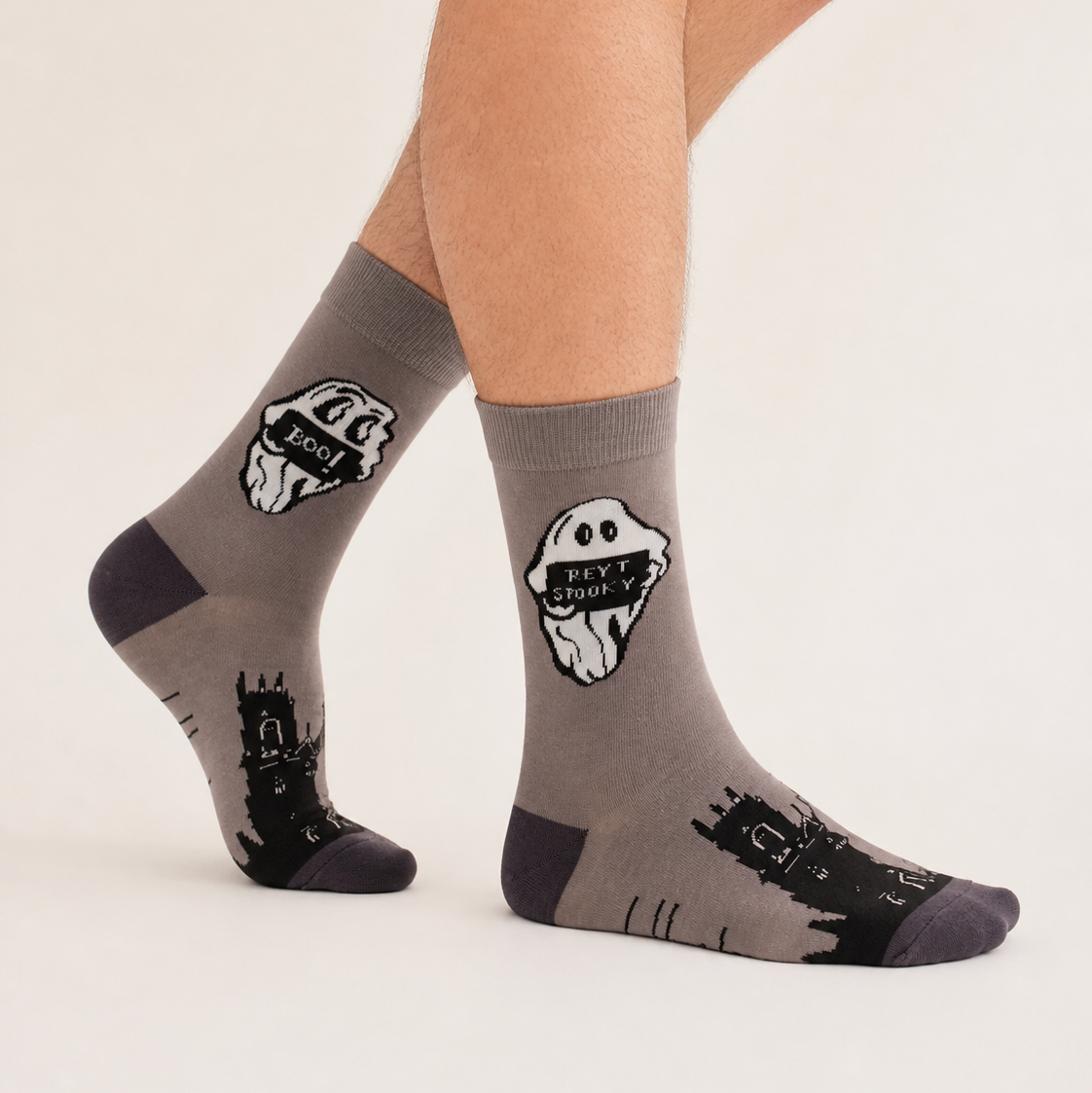A pair of crew socks worn on a person's feet, shown against a plain light beige studio background. 