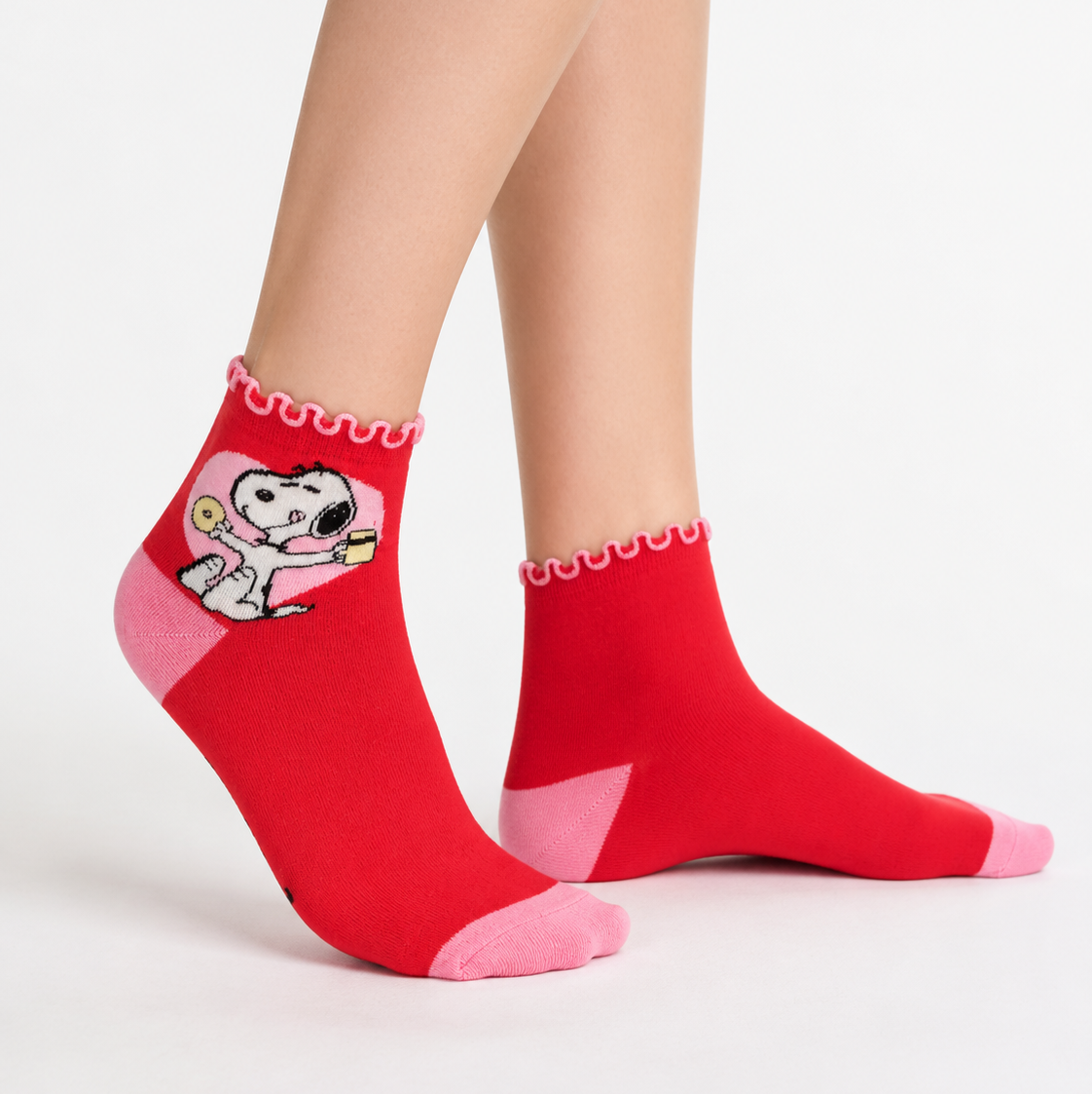 A pair of ankle socks featuring snoopy enjoying some sweet treats. 