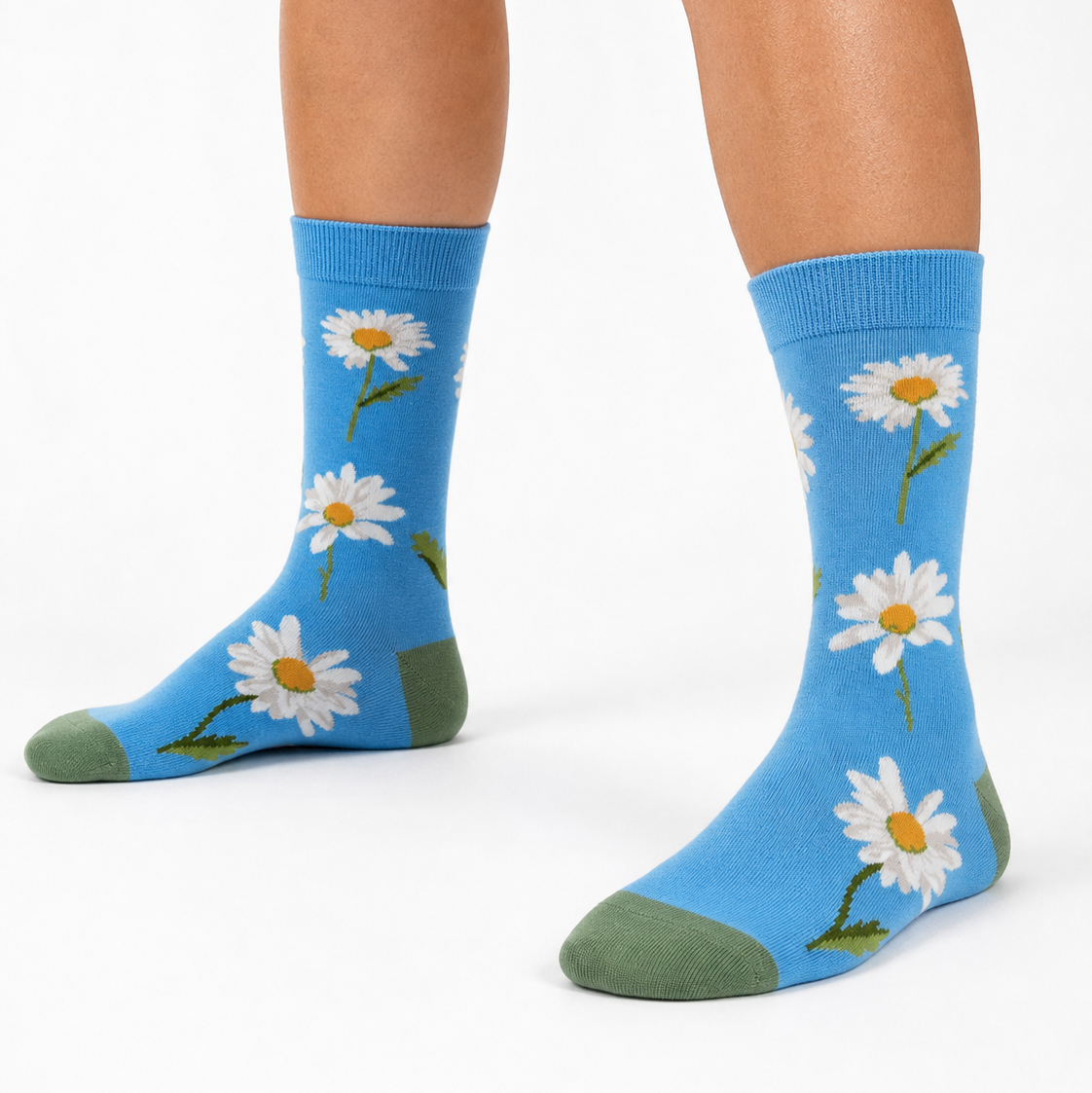 A pair of crew socks featuring daisies on a blue background.  